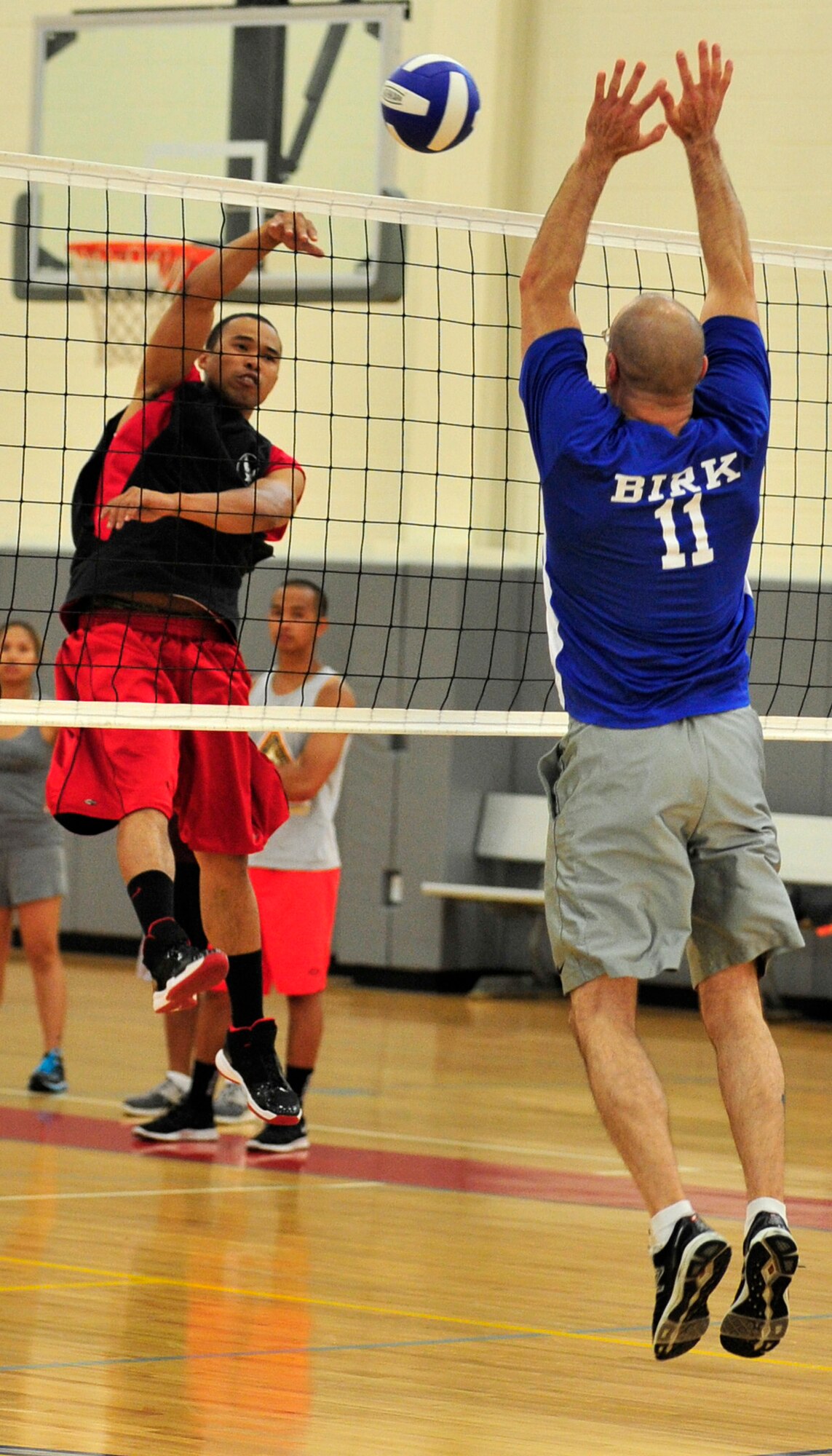 James Jones, 736th Aircraft Maintenance Squadron player-coach, goes up for a kill as Wayne Birk, 436th Aircraft Maintenance Squadron, attempts to block during the intramural volleyball championship game May 21, 2013, at the fitness center on Dover Air Force Base, Del. The 736th AMXS won the title for the third year in a row defeating the 436th MXS 25-19, 14-25, 17-15. (U.S. Air Force photo/Tech. Sgt. Chuck Walker)