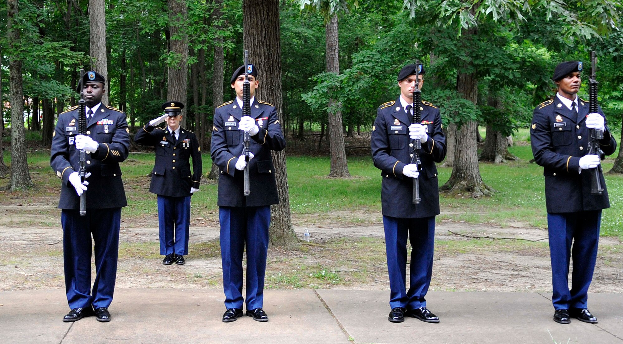 Soldiers from the 7th Sustainment Brigade perform a flag folding ceremony during the Memorial Day Ceremony at Jacobs Theater at Fort Eustis, Va., May 23, 2013. The ceremony included a guest speaker, a performance by the U.S. Army Training and Doctrine Command Band and a 21-gun salute in honor of fallen U.S. Service members. (U.S. Air Force photo by Staff Sgt. Dana Hill/Released)