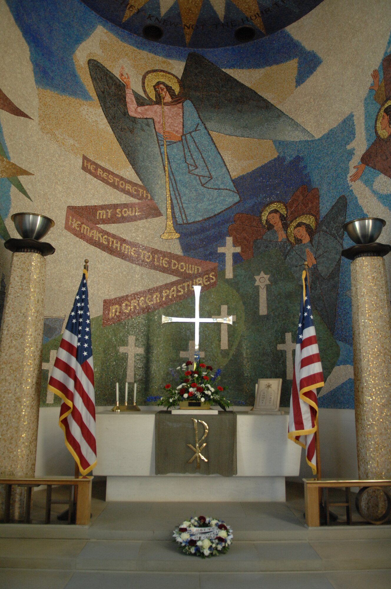 A wreath lies at an altar May 27, 2013, in the chapel at the Madingley American Cemetery in Cambridge, England. Mosaics depicting angels and ghostly aircraft heading toward resurrection and last judgment decorate the walls and ceiling of the chapel. (U.S. Air Force photo by Airman 1st Class Dillon Johnston/Released)