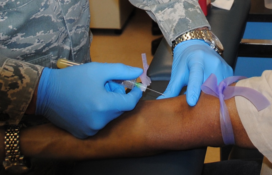Staff Sgt. Thomas C. Sullivan Jr., 319th Medical Support Squadron laboratory technician, prepares to take a blood sample from retired Master Sgt. Stephen Tyler May 22, 2013, at the medical laboratory on Grand Forks Air Force Base, N.D. Lab technicians usually ask patients what side they prefer to be injected as a way of making patients feel more comfortable. (U.S. Air Force photo/Staff Sgt. Luis Loza Gutierrez)
