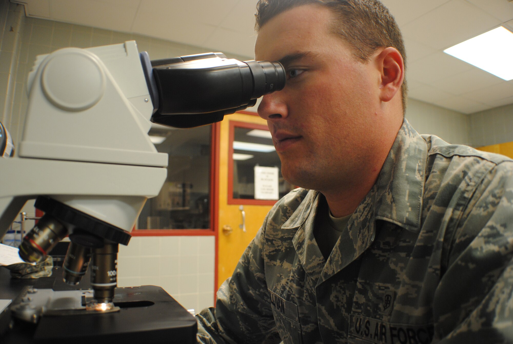 Staff Sgt. Thomas C. Sullivan Jr., 319th Medical Support Squadron laboratory technician, adjusts the focus on microscope May 22, 2013, at the medical laboratory on Grand Forks Air Force Base, N.D. The base medical laboratory services are accredited by the College of American Pathologists. (U.S. Air Force photo/Staff Sgt. Luis Loza Gutierrez)