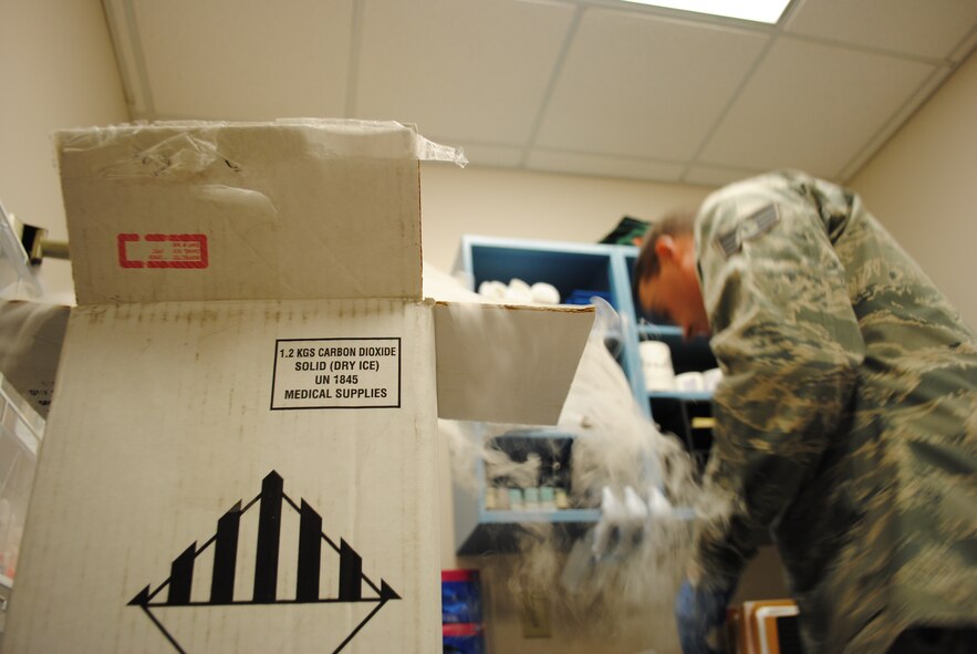 Staff Sgt. Thomas C. Sullivan Jr., 319th Medical Support Squadron laboratory technician, prepares medical samples for shipment in a box containing dry ice May 22, 2013, at the medical laboratory on Grand Forks Air Force Base, N.D. Dry ice is frequently used to preserve medical samples that must remain frozen or cold during shipment. (U.S. Air Force photo/Staff Sgt. Luis Loza Gutierrez)
