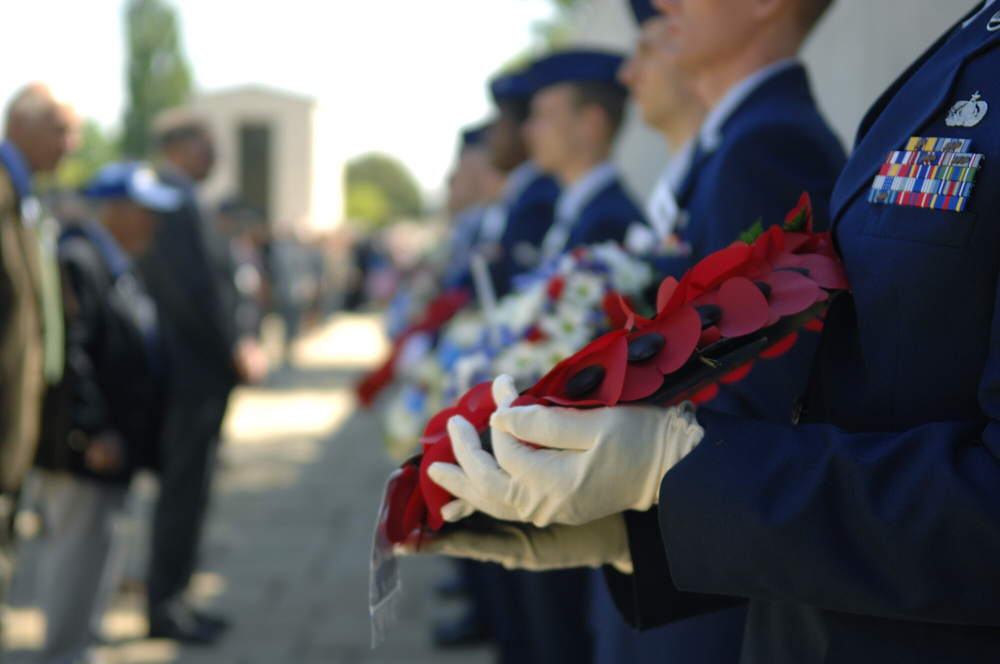An Airman holds a wreath during the Memorial Day ceremony May 27, 2013, at the Madingley American Cemetery in Cambridge, England. Memorial Day honors all service members who died during wars through history. (U.S. Air Force photo by Airman 1st Class Dillon Johnston/Released)