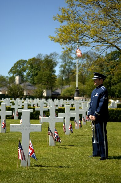 An Airman stands among the graves during the Memorial Day ceremony May 27, 2013, at the Madingley American Cemetery in Cambridge, England. More than 3,800 Americans are buried in the cemetery. (U.S. Air Force photo by Airman 1st Class Dillon Johnston/Released)