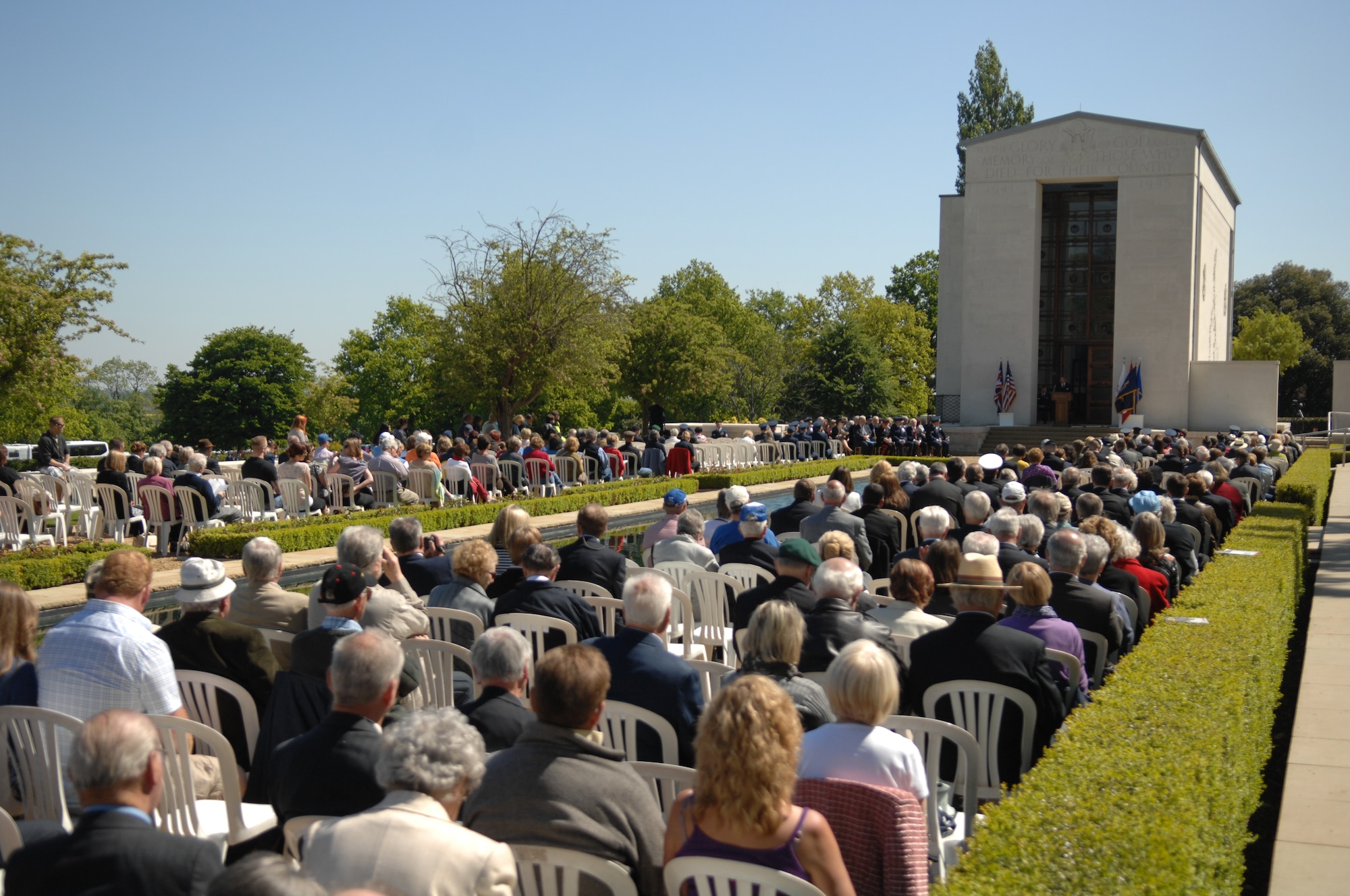 Memorial Day ceremony attendees listen to a speaker May 27, 2013, at the Madingley American Cemetery in Cambridge, England. Memorial Day honors all service members who died during wars throughout history. (U.S. Air Force photo by Airman 1st Class Dillon Johnston/Released)