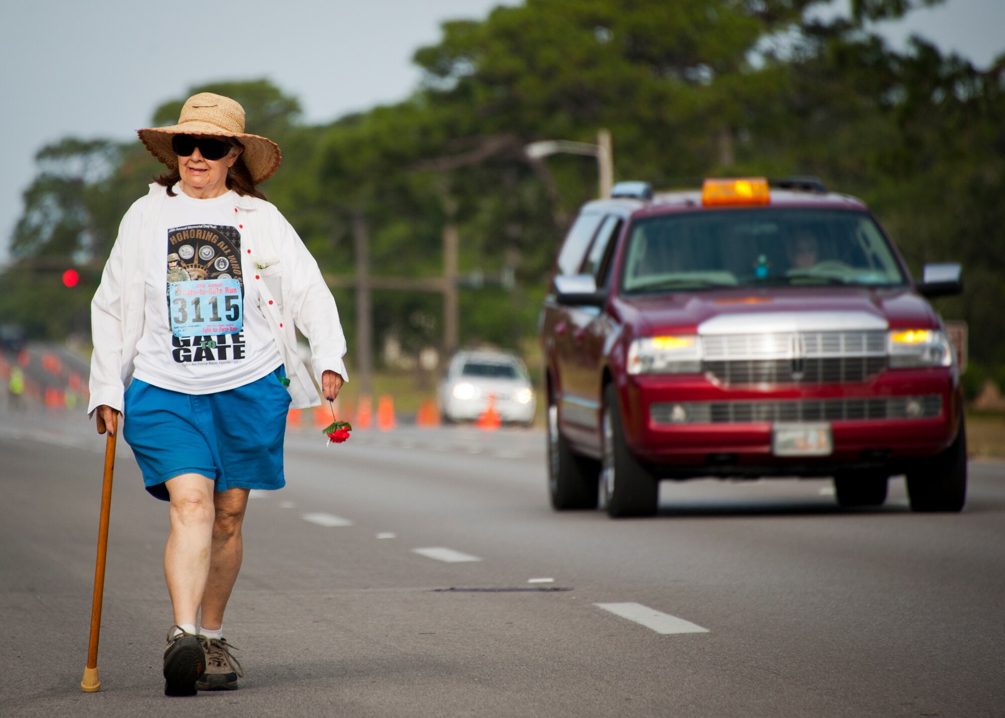Margaret Bartlett, age 84, walks down Eglin Boulevard during the 28th annual Gate-to-Gate Run May 27 at Eglin Air Force Base, Fla. More than 1,500 people participated in the Memorial Day race.  Many of the runners paid their respects by dropping off flowers in front of the All Wars Memorial as they raced by.  (U.S. Air Force photo/Samuel King Jr.)