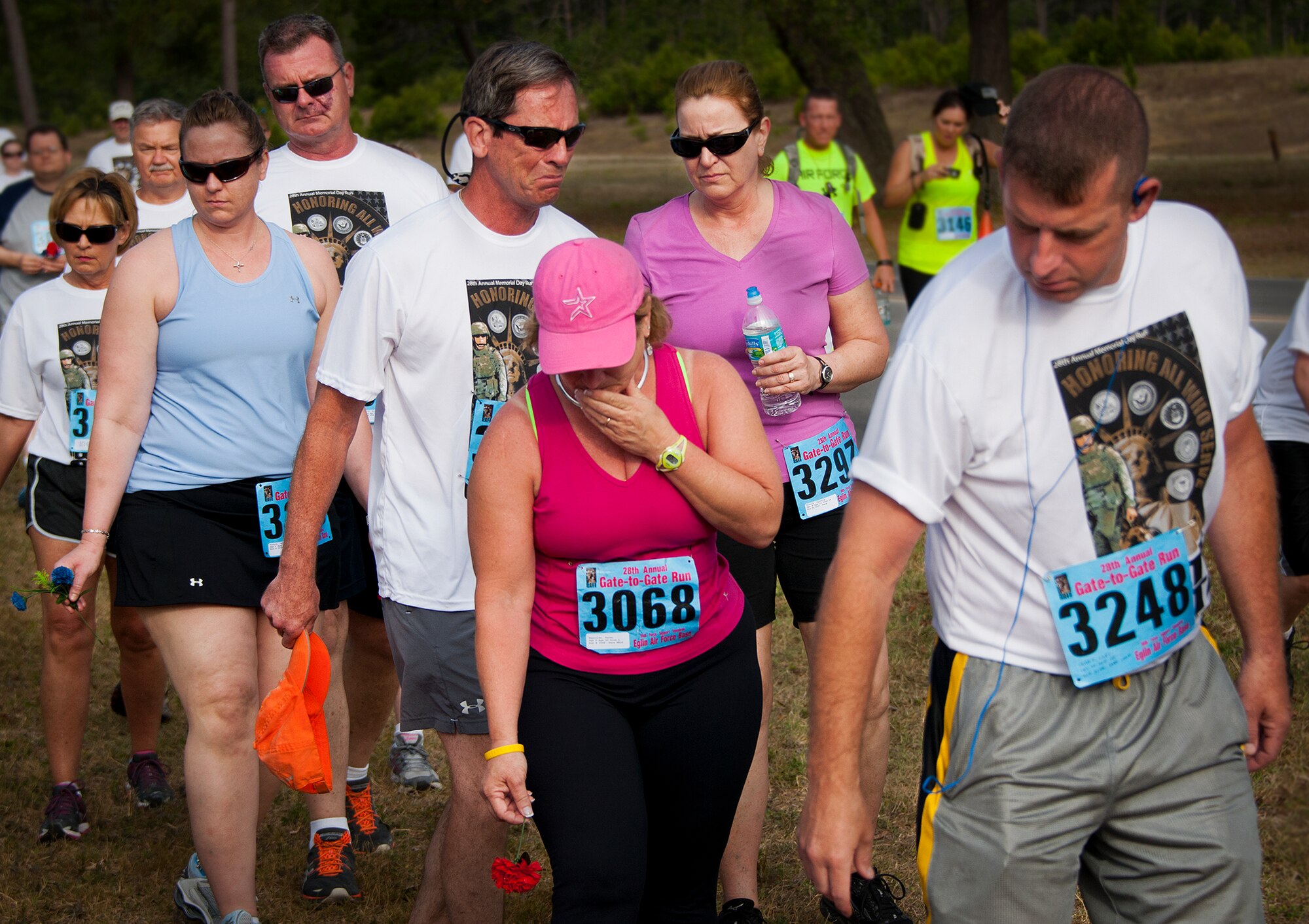 Emotions ran high for Karen and Curtis Reynolds as they passed by the All Wars Memorial during the 28th annual Gate to Gate Run May 27 at Eglin Air Force Base, Fla.  More than 1,500 people participated in the Memorial Day race.  Many of the runners paid their respects by dropping off flowers in front of the Memorial as they raced by.  (U.S. Air Force photo/Samuel King Jr.)