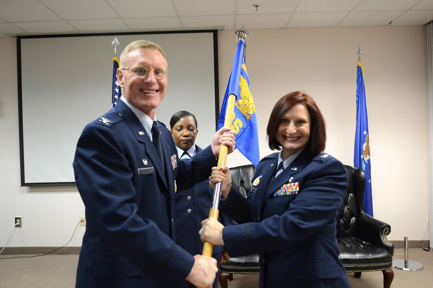 U.S. Air Force Col. Dean Borsos, 20th Medical Group commander, passes a guide-on to officially take command of the 20th Dental Squadron to Lt. Col.  Sheryl Kane at Shaw Air Force Base, S.C., May, 22, 2013.  Kane was previously the Dental flight commander and Aerospace Medical Squadron deputy commander at Moody AFB, Ga.  (U.S. Air Force photo by Airman 1st Class Nicole Sikorski/Released)  