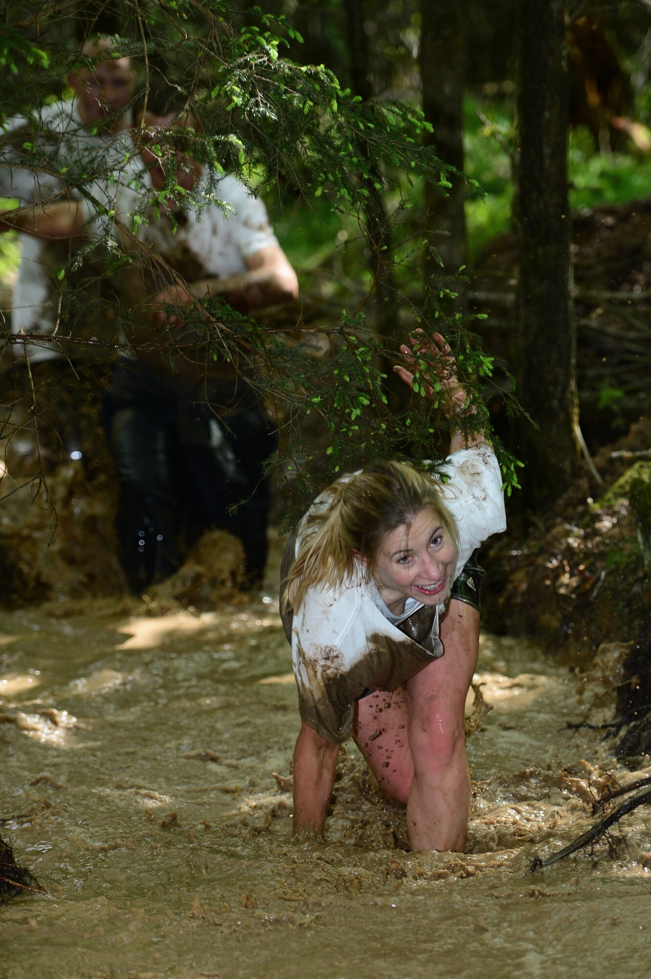 SPANGDAHLEM AIR BASE, Germany - U.S. Air Force Staff Sgt. Brandy Vinton, 52nd Equipment Maintenance Squadron aircraft structural maintainer from Elkhart, Ind., regains her footing after tripping in the mud during the Tier II Saber Sprint May 24, 2013. During the run participants had to maneuver through several obstacles including mud pits, low crows, hay bales.  (U.S. Air Force photo by Staff Sgt. Christopher Ruano/Released)