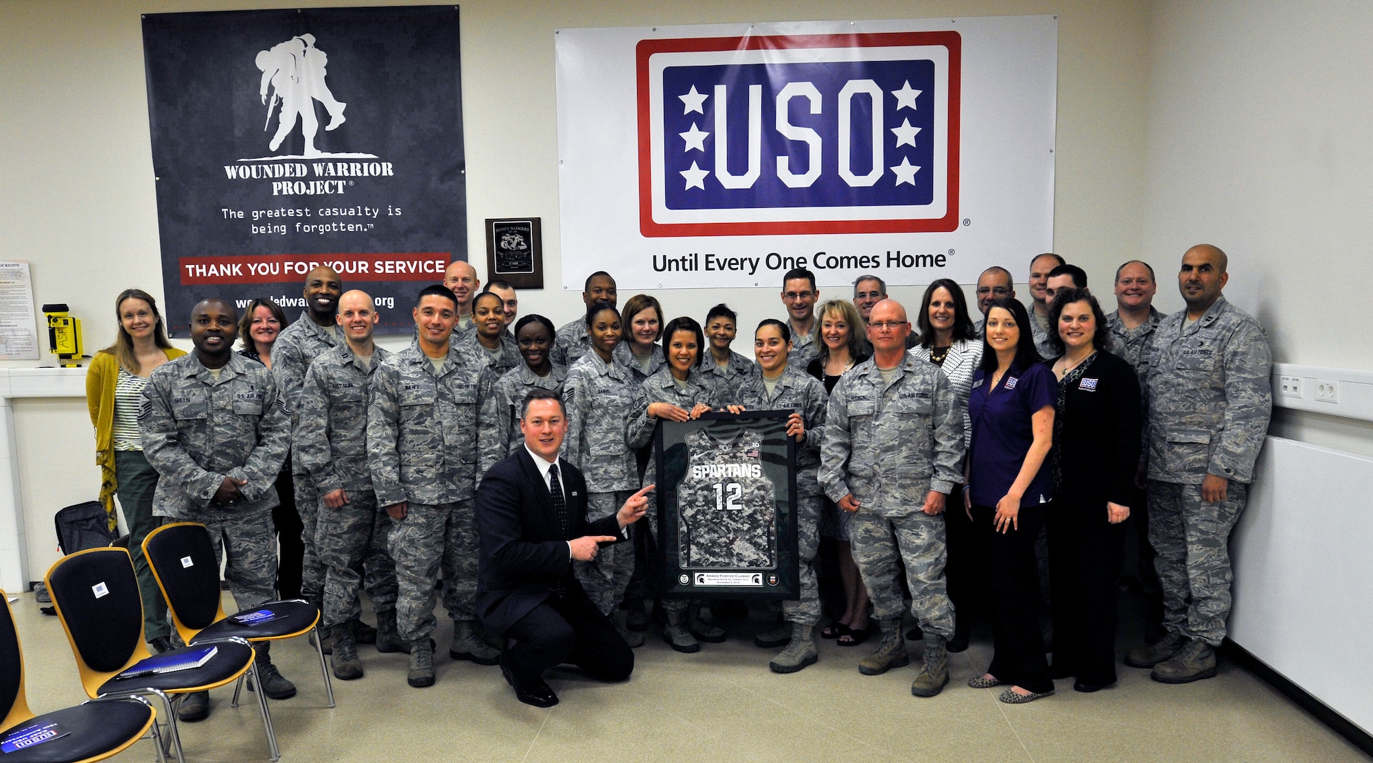 The Contingency Aeromedical Staging Facility was presented with an autographed Michigan State Spartans basketball jersey during the 10th anniversary celebration, May 22, 2013, Ramstein Air Base, Germany. The CASF USO offers a home away from home for wounded service members in transit from combat zones to the U.S. (U.S. Air Force photo/Airman 1st Class Trevor Rhynes)