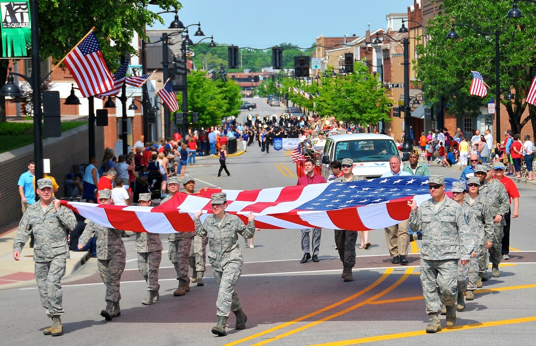 932nd Airlift Wing members show community support by marching the Amercian Flag during the Belleville Memorial Day Parade May 27th, Belleville IL. 