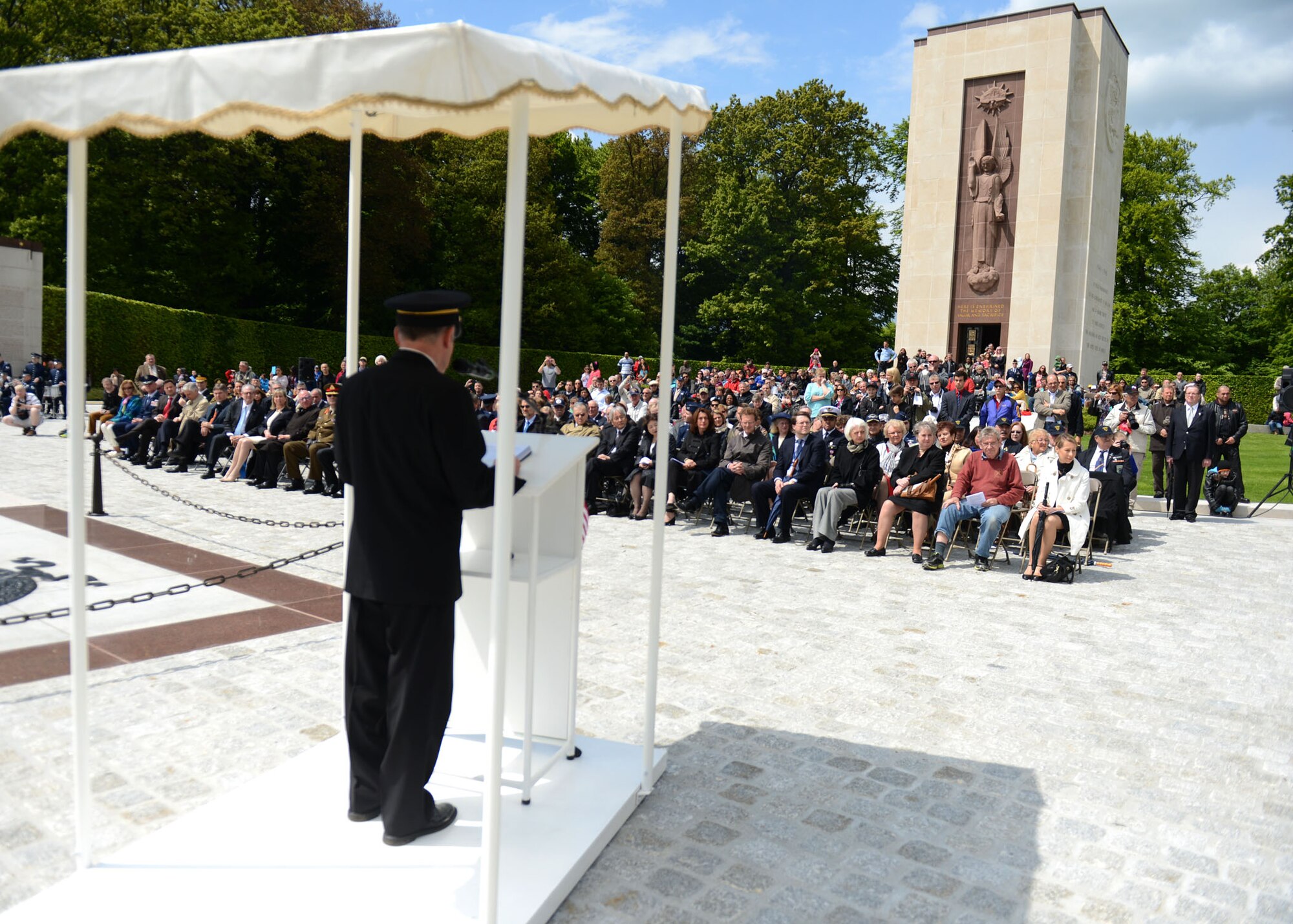 LUXEMBOURG – People listen to opening remarks during a Memorial Day commemoration at the Luxembourg American Military Cemetery and Memorial May 25, 2013. The cemetery contains the remains of more than 5,000 American service members, most who died during the Battle of the Bulge fought nearby. (U.S. Air Force photo by Airman 1st Class Gustavo Castillo/Released)
