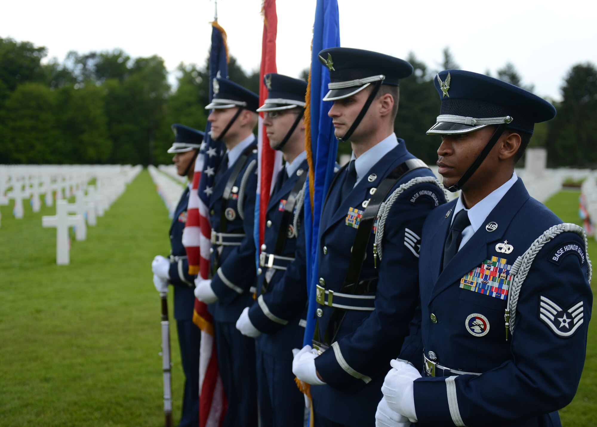 LUXEMBOURG – Members of the Spangdahlem honor guard stand in formation during a Memorial Day commemoration at the Luxembourg American Military Cemetery and Memorial May 25, 2013. As part of the formation, the Airmen posted and presented the flags during a 21-gun salute and the playing of taps to mark the end of the ceremony. (U.S. Air Force photo by Airman 1st Class Gustavo Castillo/Released)
