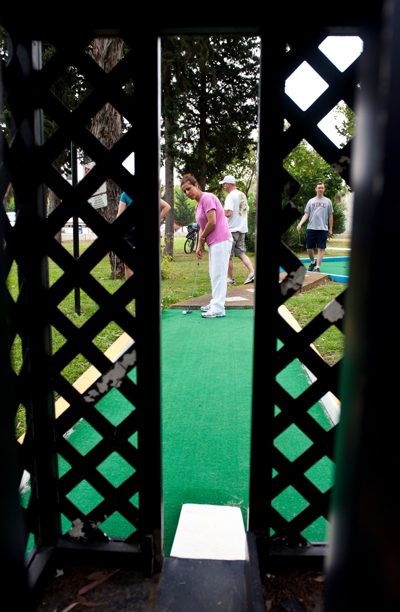 Methap Kuykendall, 39th Air Base Wing, lines up her shot on the putt-putt golf course for 39th ABW Sports Day May 24, 2013, at Incirlik Air Base, Turkey. Sports day consisted of Incirlik Airmen competing in various sporting events ranging from tug-of-war and kickball to bowling and golf. (U.S. Air Force photo by Senior Airman Daniel Phelps/Released)