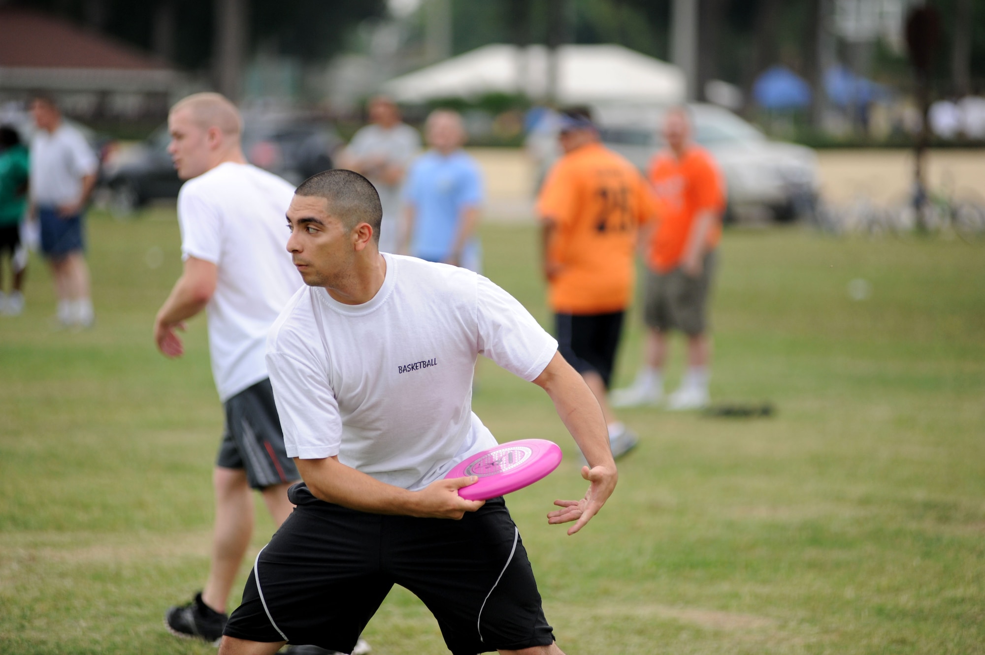 Christopher Kenny, 39th Communications Squadron, makes a pass in a game of ultimate frisbee during the 39th Air Base Wing Sports Day May 24, 2013, at Incirlik Air Base, Turkey. Sports day consisted of Incirlik Airmen competing in 10 different sporting events ranging from dodgeball and kickball to corn hole toss and golf. (U.S. Air Force photo by Senior Airman Jarvie Z. Wallace/Released) 