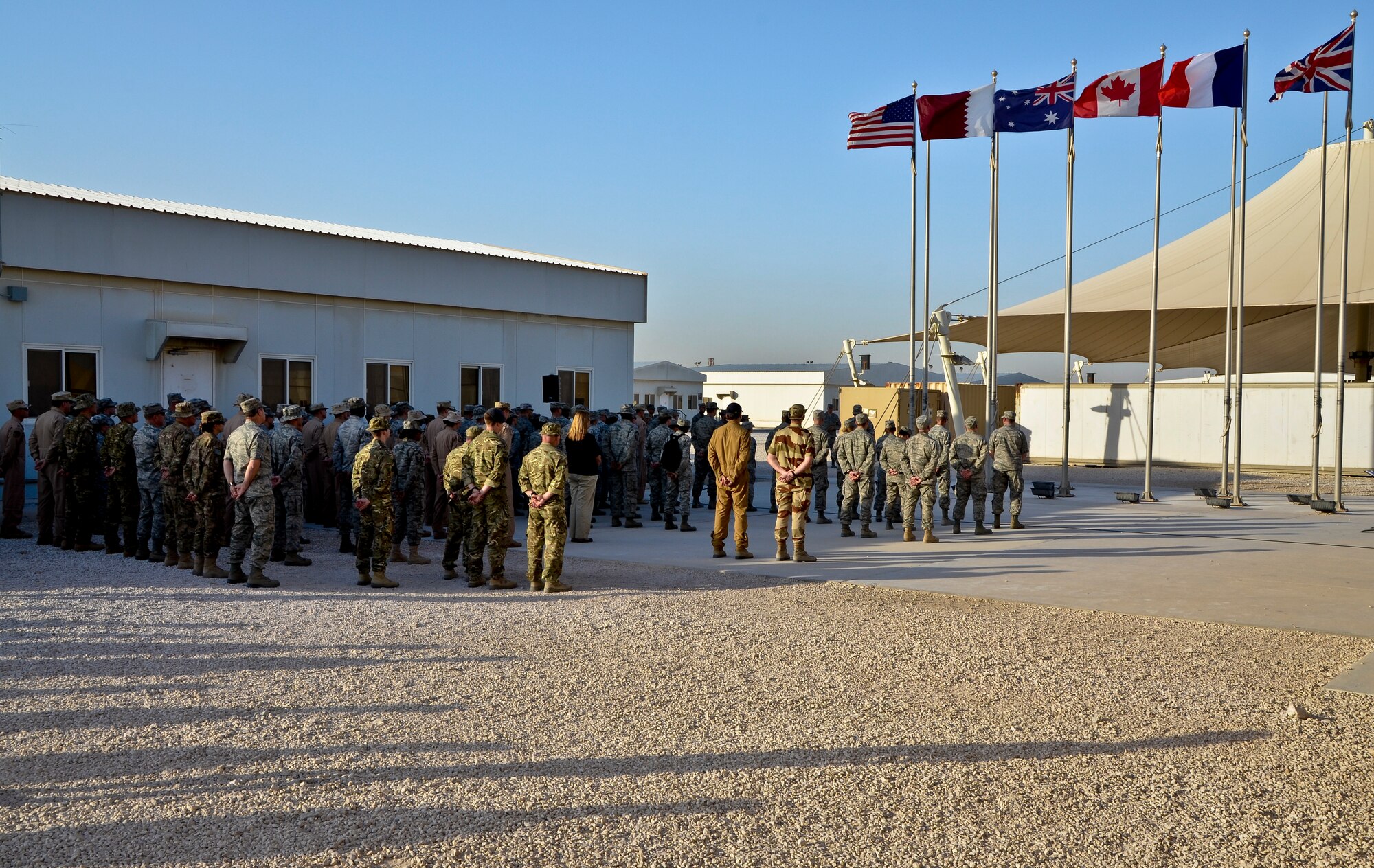 U.S. and coalition forces deployed to the 379th Air Expeditionary Wing take part in a Memorial Day retreat ceremony, May 27, 2013, at Memorial Plaza in Southwest Asia. The ceremony included a few words from the 379th AEW commander, Brig. Gen. Roger H. Watkins, an invocation and prayer by the wing chaplain, Col. Bruce Glover, and taps played by Chaplain (Capt.) James Bastian. (U.S. Air Force photo/Senior Airman Benjamin Stratton)