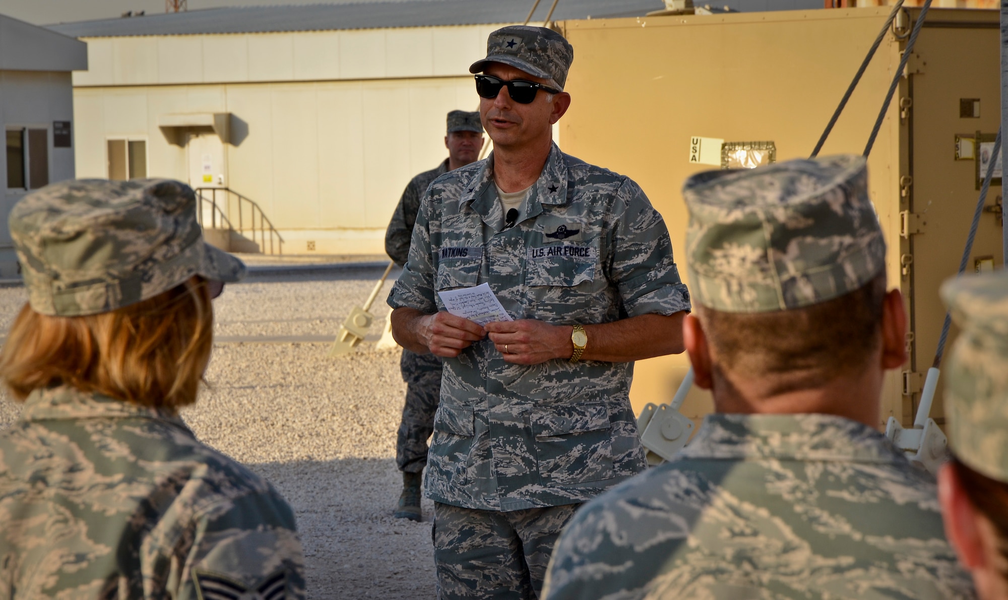 Brig. Gen. Roger H. Watkins addresses U.S. and coalition forces deployed to the 379th Air Expeditionary Wing during a Memorial Day retreat ceremony, May 27, 2013, at Memorial Plaza in Southwest Asia. Watkins is the 379th AEW commander. (U.S. Air Force photo/Senior Airman Benjamin Stratton)
