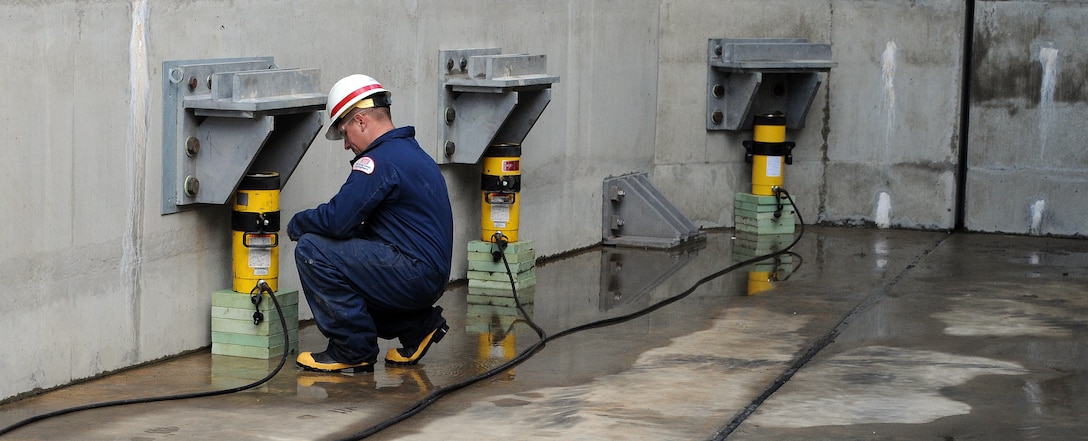 A member of the maintenance team at Lake Kaweah, near Lemon Cove, Calif., readies equipment for a regular test of one of the giant fuse gates of Terminus Dam, a facility operated by the U.S. Army Corps of Engineers Sacramento District. (U.S. Army photo by Tyler Stalker/Released)