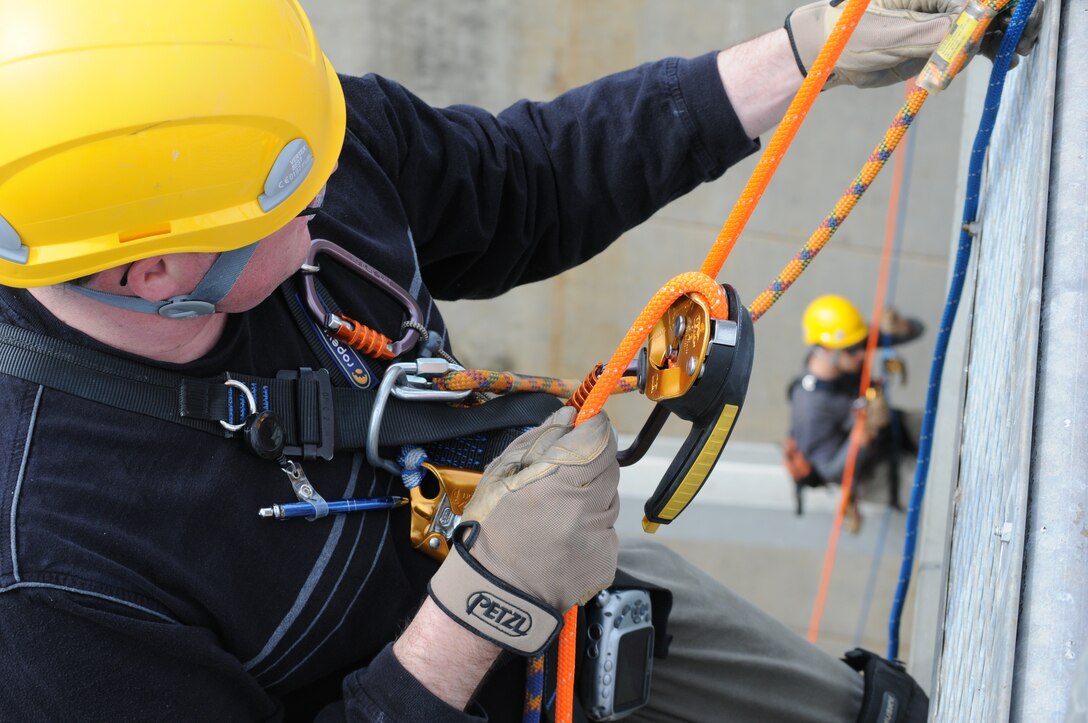 Levi Bowers (left) and Christopher Abela, engineers and climb team members with the U.S. Army Corps of Engineers Sacramento District, inspect the tainter gates at New Hogan Dam near Valley Springs, Calif., April 10, 2012. Tainter gates are a type of flood gate used in dams to control water flow. New Hogan Dam reduces flood risk to the city of Stockton and stores water used for irrigation, drinking and hydroelectric power. (U.S. Army photo by John Prettyman/Released)