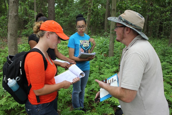 Bill Rutlin, a regulatory specialist with the U.S. Army Corps of Engineers, helps students identify soils during a field exercise at Savannah State University.
