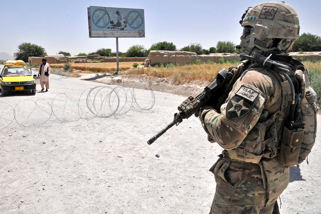 U.S. Army Spc. Christopher W. Lord provides security while other soldiers conduct a traffic control point in the Panjwai district in Afghanistan's Kandahar province, May 23, 2013. Lord is assigned to 2nd Battalion, 23rd Infantry Regiment.