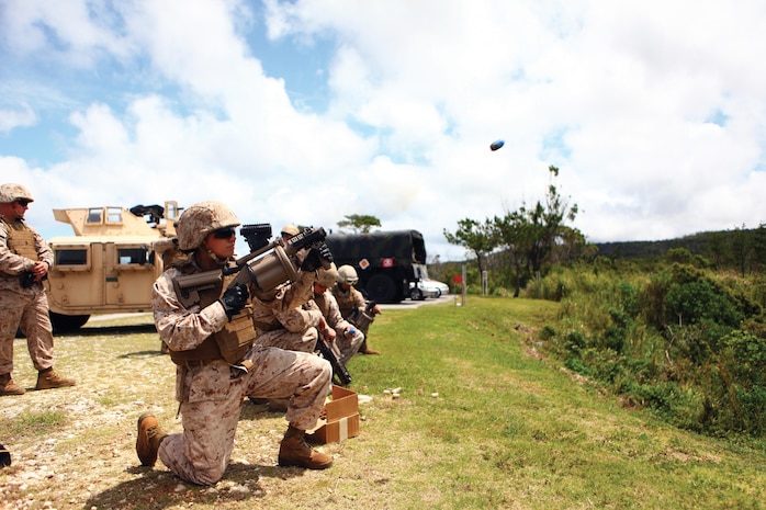 2nd Lt. Leanne Ferrell fires an M32 semiautomatic grenade launcher May 14 during a live-fire training exercise at the Central Training Area near Camp Hansen. The weapon is a shoulder-fired, semi-automatic, six-shot grenade launcher capable of firing 40 mm grenades. Ferrell is the executive officer of General Support Motor Transport Company, Combat Logistics Regiment 3, 3rd Marine Logistics Group, III Marine Expeditionary Force. 