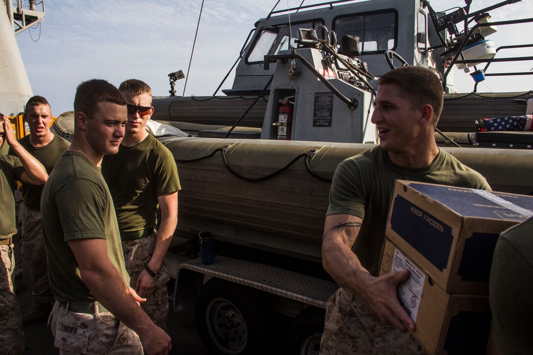 Marines and Sailors of the 26th Marine Expeditionary Unit (MEU) and Sailors of the USS Carter Hall (LSD 50) work together to complete a resupply at sea, May 28, 2013. The 26th MEU is a Marine Air-Ground Task Force forward-deployed to the U.S. 5th Fleet area of responsibility aboard the Kearsarge Amphibious Ready Group serving as a sea-based, expeditionary crisis response force capable of conducting amphibious operations across the full range of military operations.
(U.S. Marine Corps photo by Cpl. Michael S. Lockett/Released)

