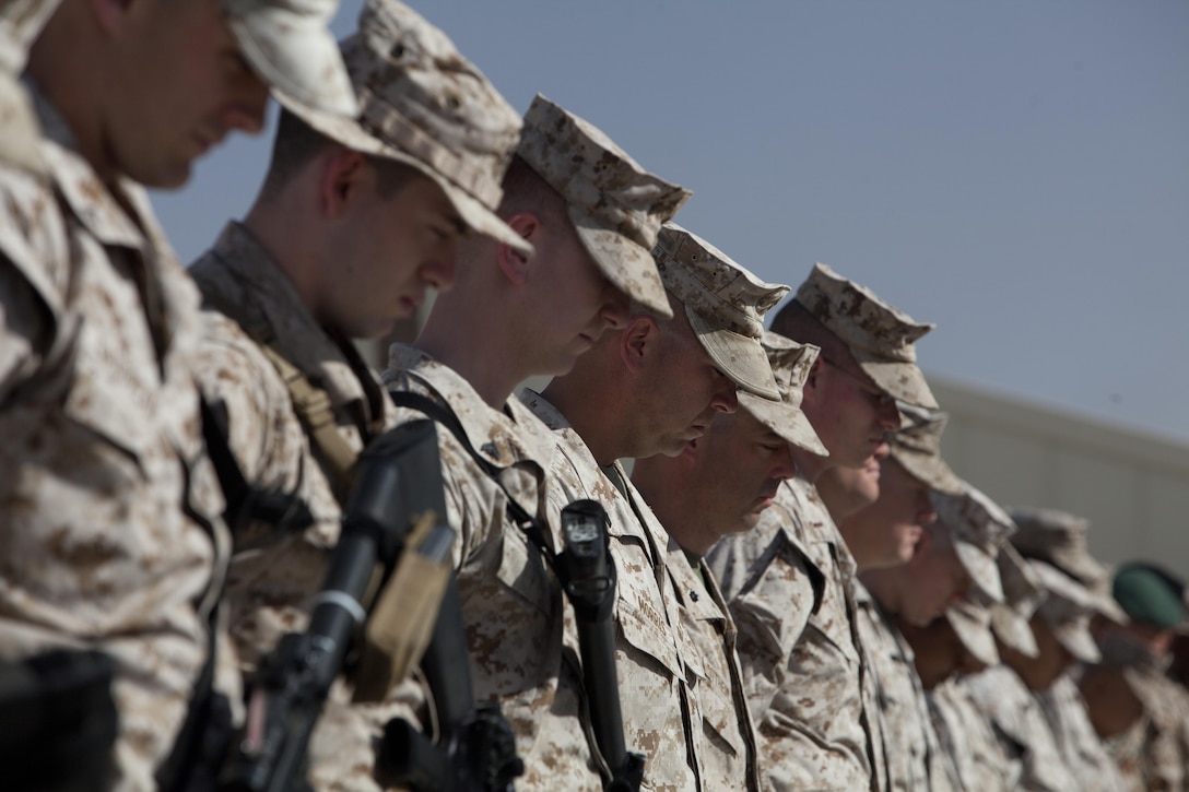 Coalition force members with Regional Command (Southwest) bow their heads in a moment of silence during a Memorial Day observance ceremony at Camp Leatherneck, Helmand province, Afghanistan, May 27, 2013. Coalition forces assigned to RC(SW) took a moment to observe Memorial Day while deployed in support of Operation Enduring Freedom. (U.S. Marine Corps Photo by Sgt. Tammy K. Hineline)