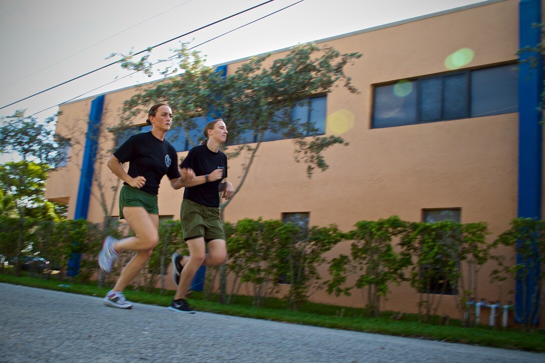 Marine Corps Sgt. Lesley Reed (left) runs with officer candidate Candice Heizmann during a physical training session April 18, 2013. A graduate of Florida Atlantic University, Heizmann has already completed half of OCS through the Platoon Leaders Course in 2010 and will return to finish her training this summer. Reed has volunteered to mentor the future officer to better prepare her to be a leader of Marines. 
