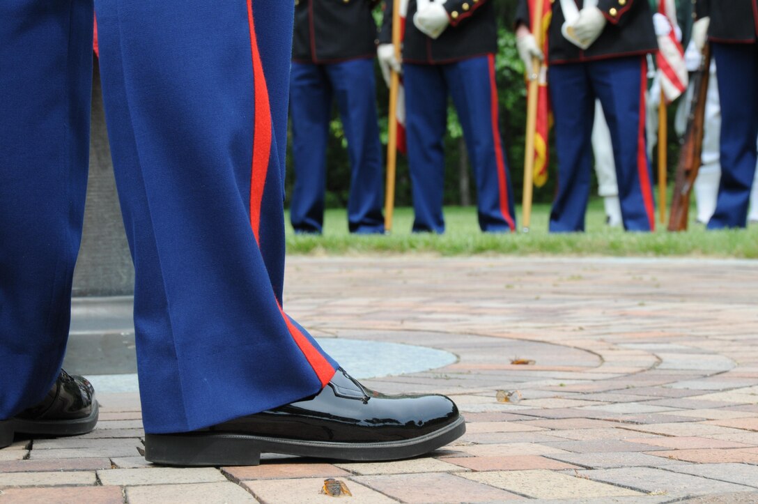 Corporal Daniel Musgrove, a member of the flag detail, Marine Corps Base Quantico ceremonial platoon, stands ready to hoist the national ensign during the Potomac Region Veterans Council Memorial Day Ceremony at Quantico National Cemetery on May 27, 2013. The event has been held for 30 years, paying homage fallen service members.
