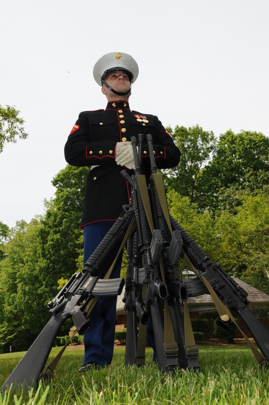 Lance Cpl. Michael Noyes, a rifle bearer with Marine Corps Base Quantico’s ceremonial platoon, stands guard over a rifle stack prior to the Potomac Region Veterans Council Memorial Day Ceremony at Quantico National Cemetery on May 27, 2013. The day, originally called Decoration Day, is a day of remembrance for those who have died in service to our nation.