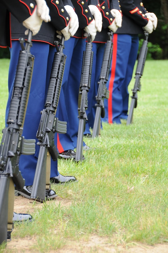 Rifle bearers from the Marine Corps Base Quantico Ceremonial Platoon stand at ceremonial at ease during the Potomac Region Veterans Council Memorial Day Ceremony held at Quantico National Cemetery on May 27, 2013. The event has been held for 30 years, paying homage fallen service members.