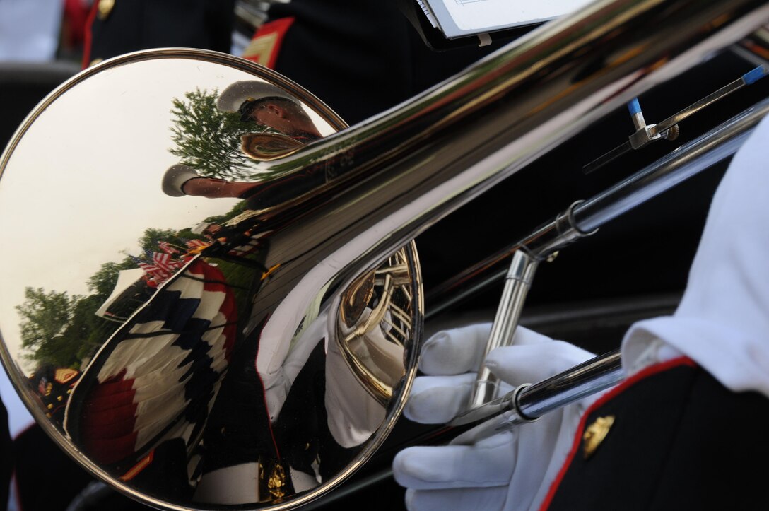 A trombonist with the Quantico Marine Band plays “God Bless America” during the Potomac Region Veterans Council Memorial Day Ceremony held at Quantico National Cemetery on May 27, 2013. The day, originally called Decoration Day, is a day of remembrance for those who have died in service to our nation.