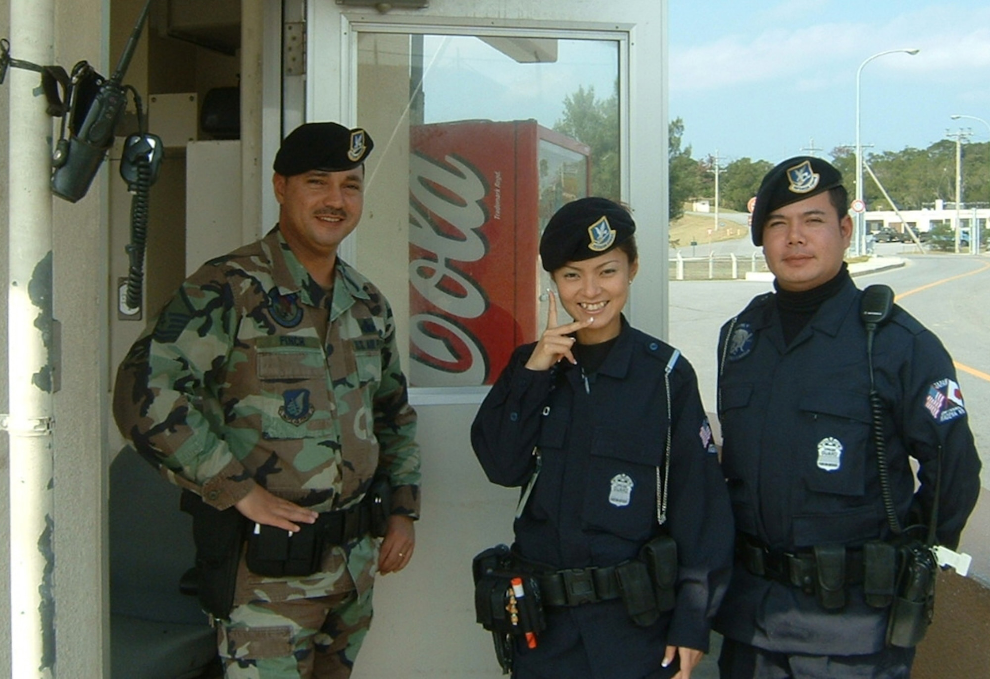 Shoko Higa, former 18th Security Forces Squadron civilian guard (center), poses for a picture with her fellow co-workers on Kadena Air Base, Japan, Dec. 3, 2005. Before becoming a civilian guard with the security forces squadron, Higa was a contractor with the 733rd Air Mobility Squadron. (Courtesy photo/Released)