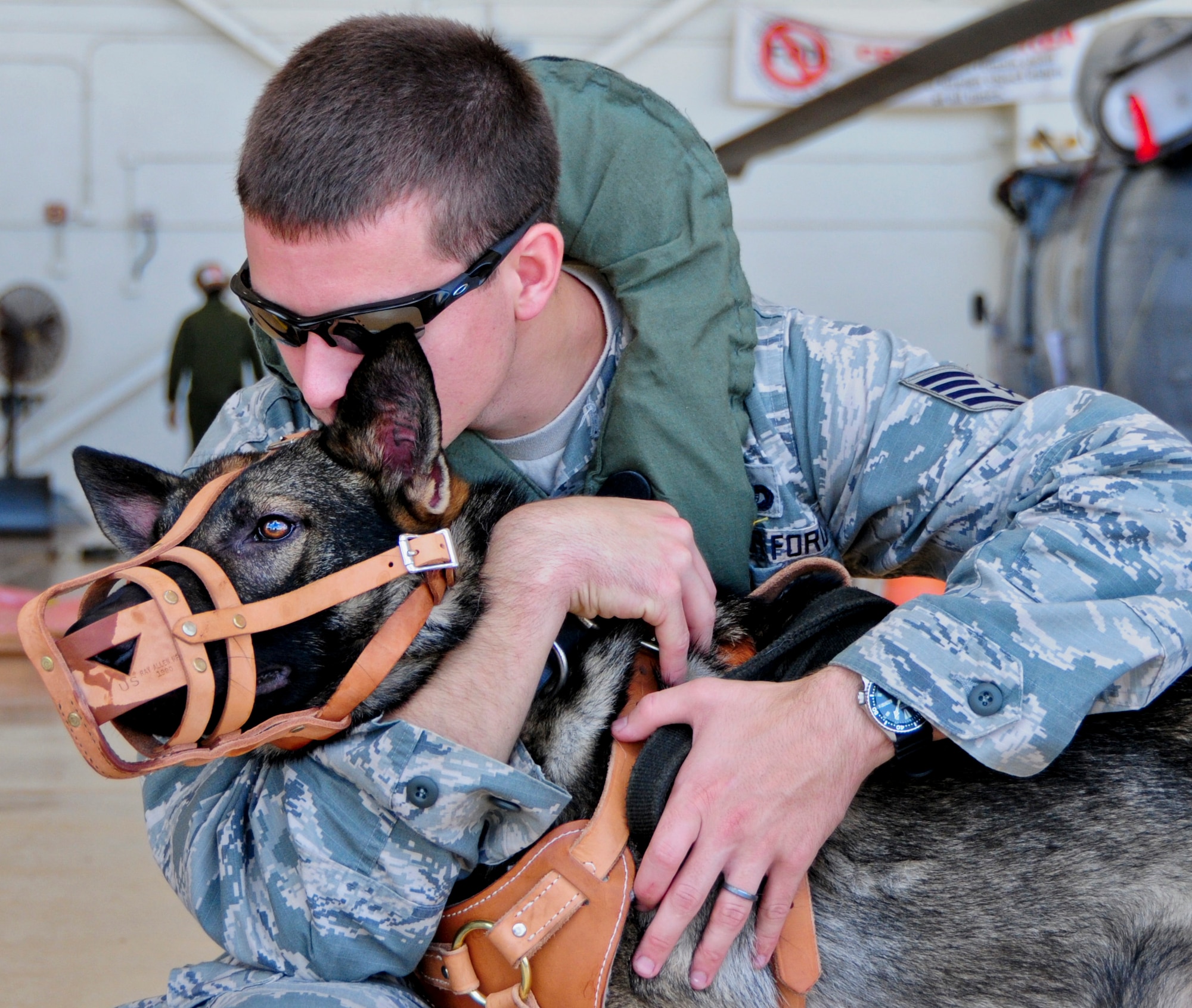 Staff Sgt. Joseph Teresi, 36th Security Forces Squadron military working dog handler, calms Viktor, 36th SFS MWD, before boarding an MH-60S Seahawk helicopter May 23, 2013, on Andersen Air Force Base, Guam. With the help of U.S. Navy Helicopter Sea Combat Squadron 25, 36th SFS handlers train MWDs at least once a quarter on helicopter familiarization. (U.S. Air Force photo by Airman 1st Class Marianique Santos/Released)