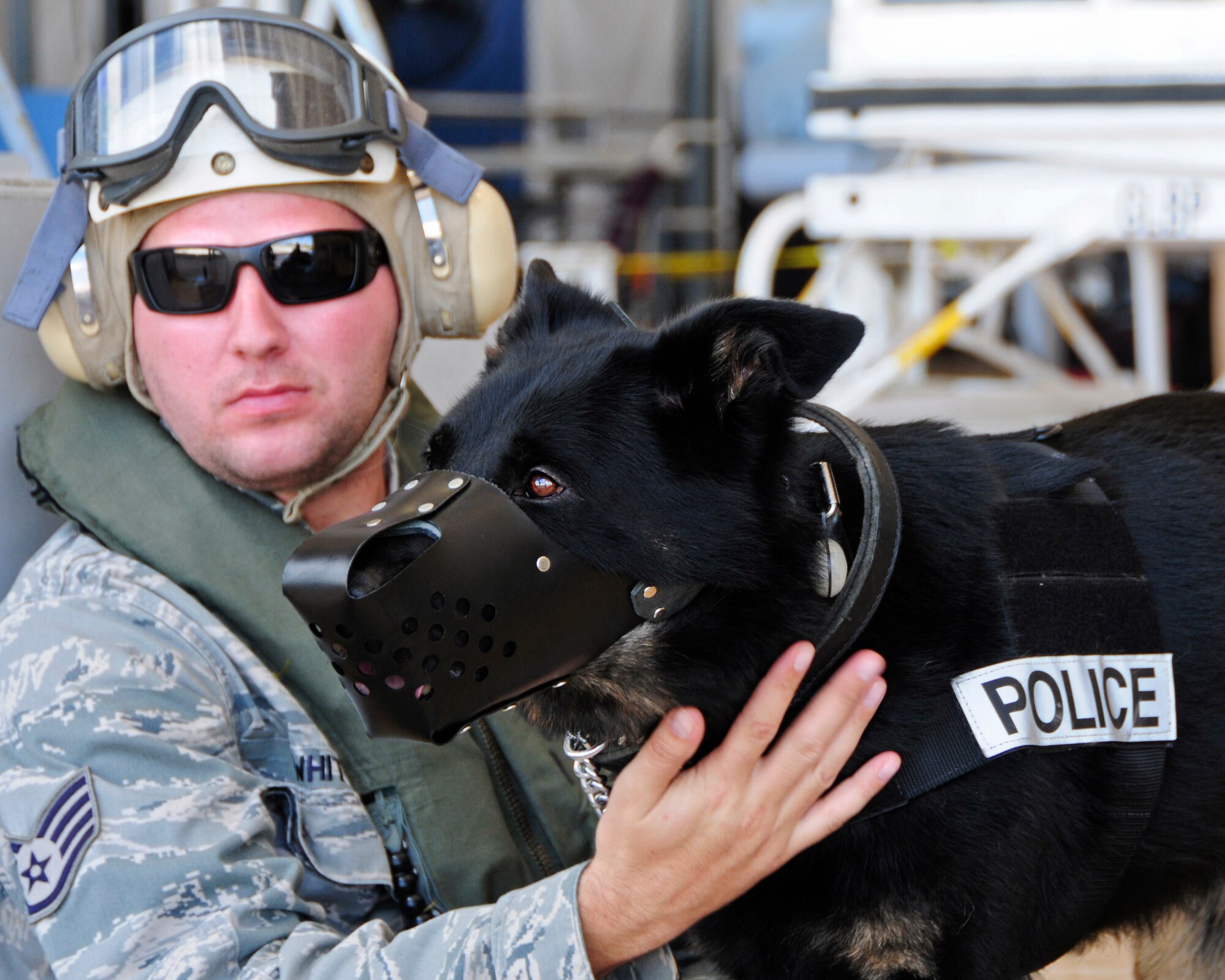 Staff Sgt. Terry White, 36th Security Forces Squadron military working dog handler, pets Arno, 36th SFS MWD, while waiting to board an MH-60S Seahawk helicopter May 23, 2013, on Andersen Air Force Base, Guam. The training oriented MWDs for helicopter operations, and ultimately enhanced deployment readiness and the modes of transportation available to MWD teams while traveling throughout an area of responsibly. (U.S. Air Force photo by Airman 1st Class Marianique Santos/Released)