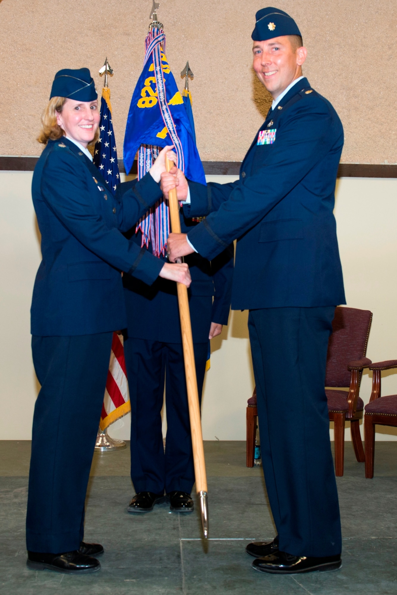 Lt. Col. Ann Birchard, Hurlburt Field 823rd RED HORSE deputy commander, passes the 823rd RED HORSE, Det. 1 guidon to Major Steven J. Thomas during a change of command ceremony May 29.  (U.S. Air Force photo by Lisa Norman)