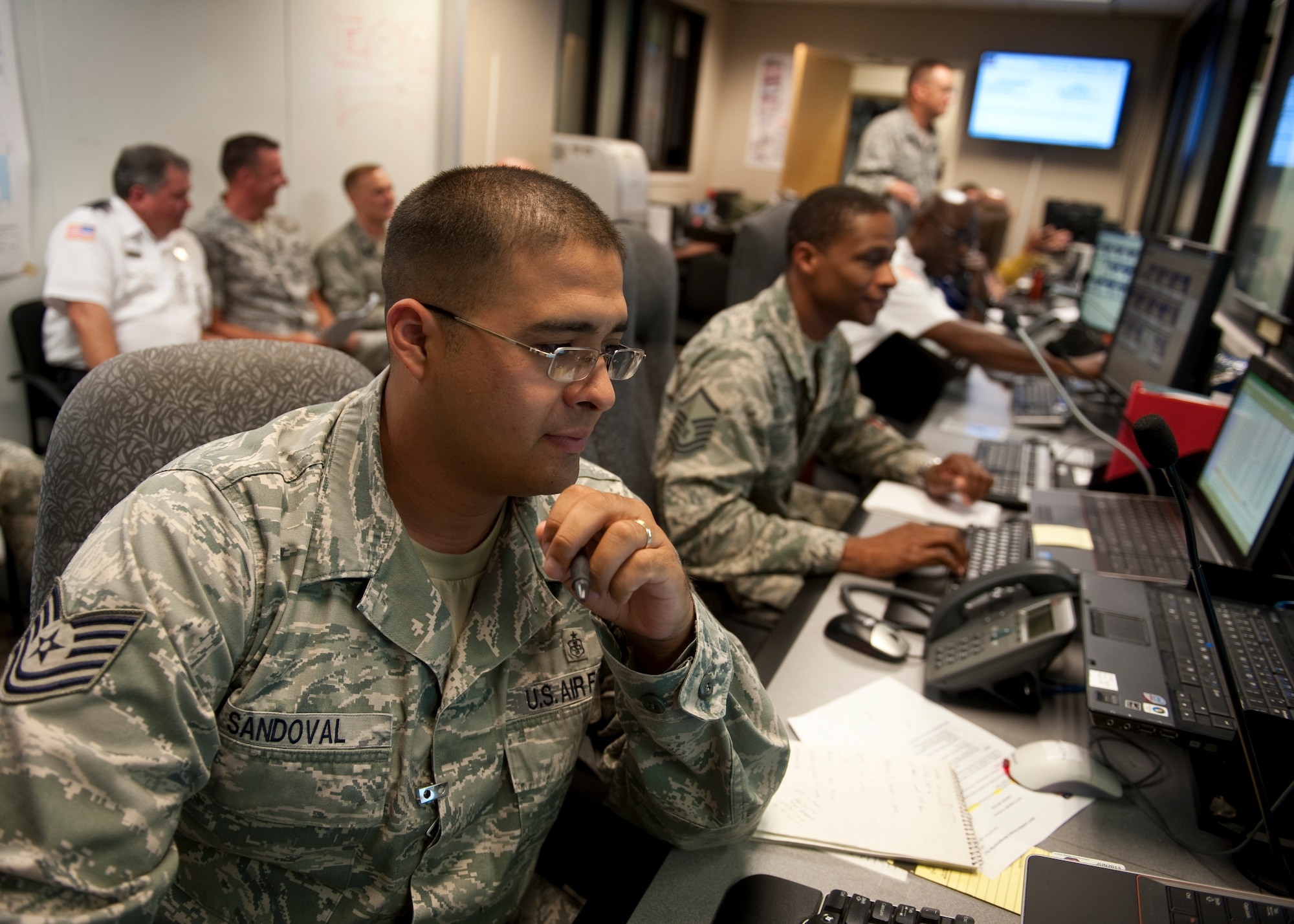 U.S. Air Force Tech. Sgt. Ray Sandoval, noncommissioned officer-in-charge of medical readiness of 1st Special Operations Medical Support Squadron, reviews weather reports and storm patterns during the 2013 Hurricane Exercise at the Emergency Operations Center on Hurlburt Field, Fla. May. 22, 2013. (U.S. Air Force photo/ Senior Airman Kentavist Brackin)