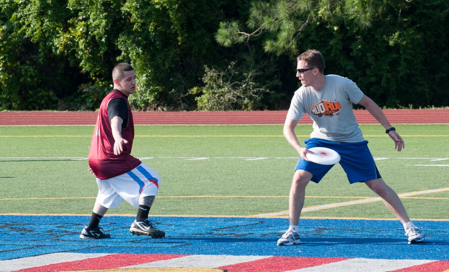 Adrian Gomez, a member of the 1st Special Operations Wing team, attempt to block a pass by Jon Rodgers, a member of the 4th Special Operations Squadron, during the first game of the first Ultimate Frisbee season hosted on Hurlburt Field, Fla., May 21, 2013. (U.S. Air Force photo by Airman 1st Class Jeffrey Parkinson)