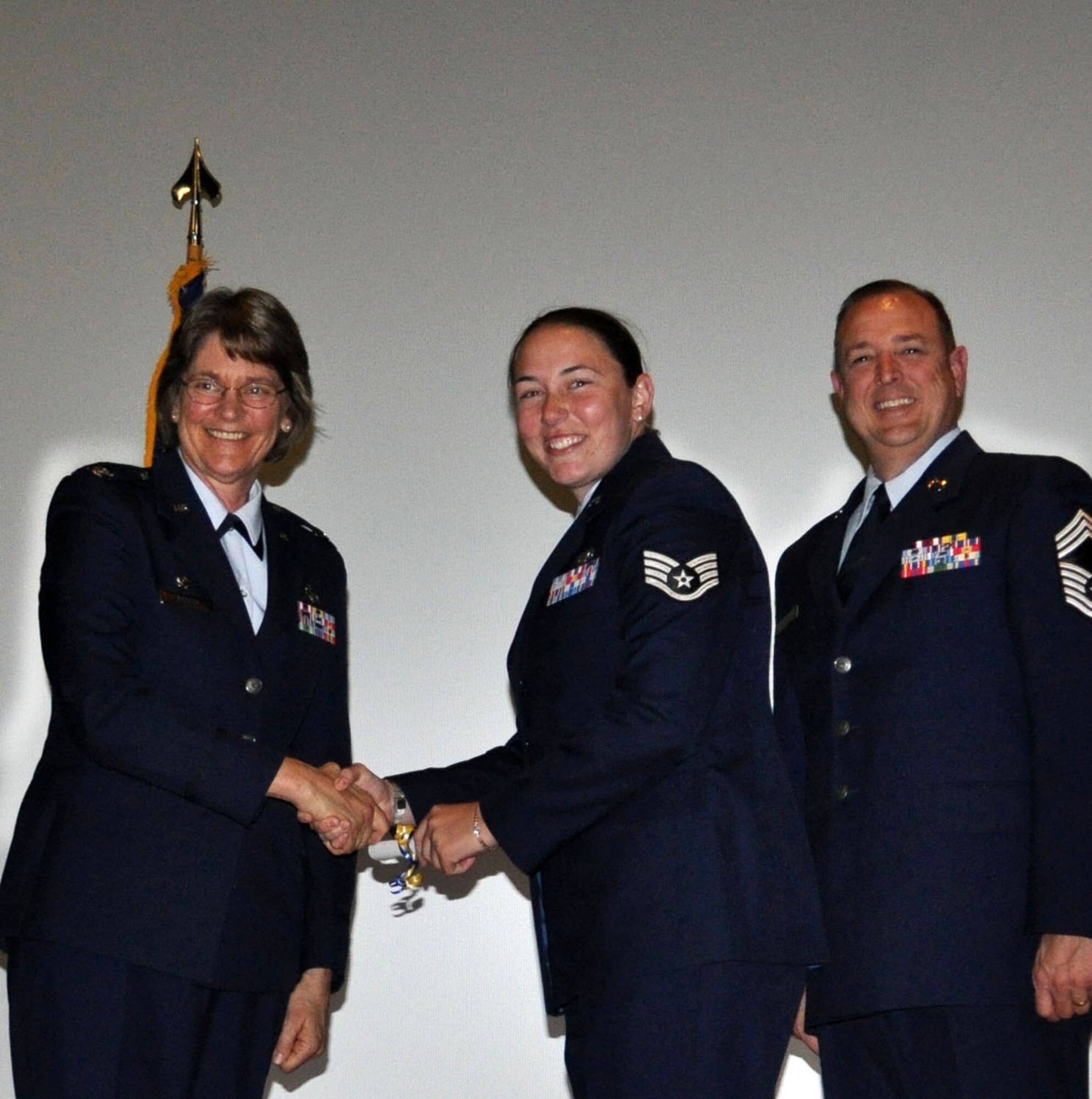 TRAVIS AIR FORCE BASE, Calif. -- Col. Nancy Brooks, 349th Mission Support Group Commander, presents Staff Sgt. Chelsea Eckenrode with her CCAF degree Apr. 30, 2013. The Travis Air Force Base reservist is assigned to the 45th Aerial Port Squadron. (U.S. Air Force photo/Tech. Sgt. Moses Gines)