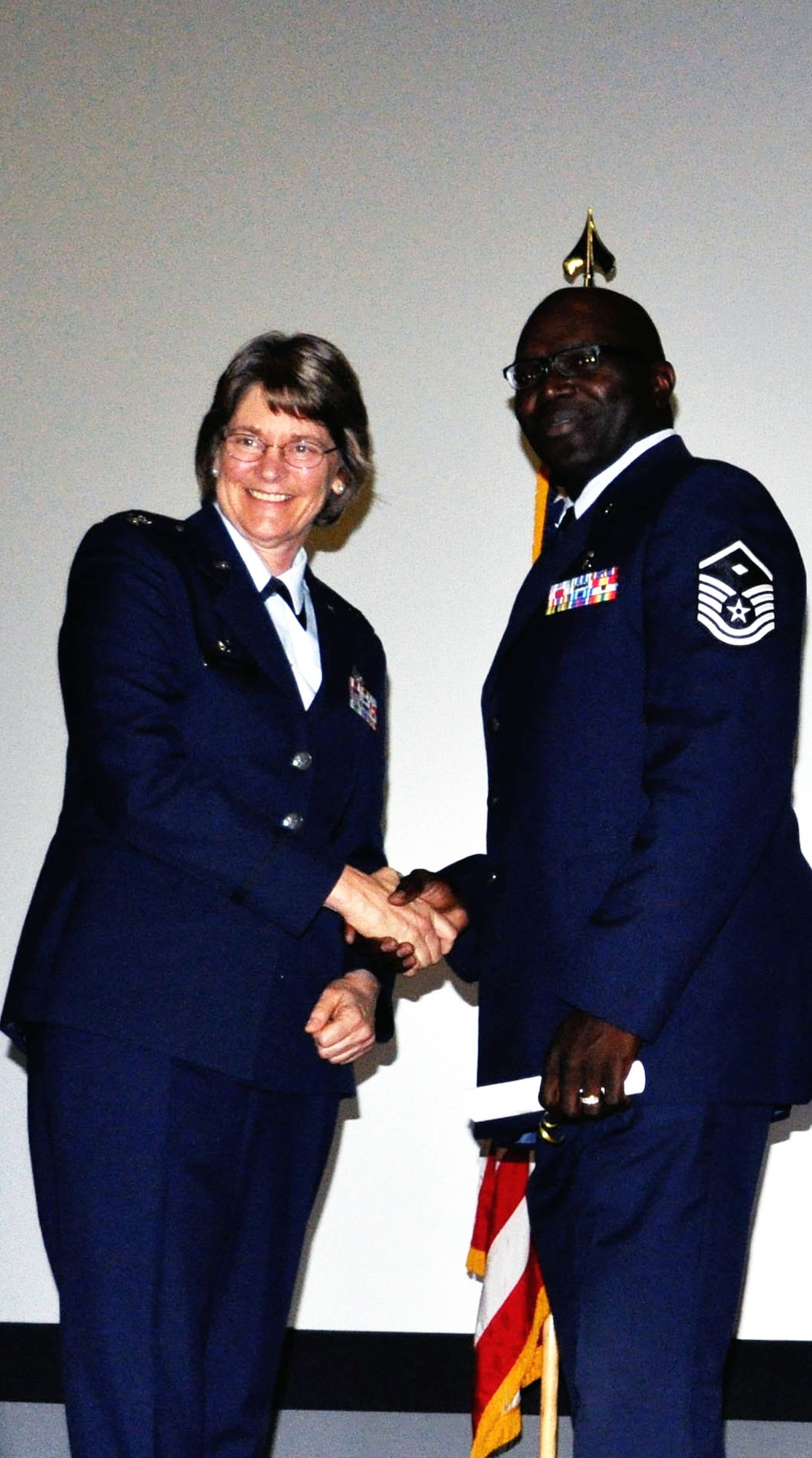 TRAVIS AIR FORCE BASE, Calif. -- First Sergeant for the 349th Medical Squadron, Master Sgt. Roderick Lee receives his CCAF degree from Col. Nancy Brooks, 349th MSG commander. Lee was one of 38 reservists at Travis AFB to be conferred with his degree Apr. 30, 2013. (U.S. Air Force photo/Tech. Sgt. Moses Gines)