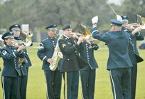 A ceremonial band with U.S. Army and Air Force members play a medley of of military service songs during the 502nd Air Base Wing and Joint Base San Antonio change of command ceremony May 29, 2013, at 9 a.m. at JBSA-Fort Sam Houston's MacArthur Parade Field. (U.S. Air Force photo by Benjamin Faske) (released)