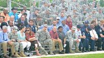 JBSA members sit in the stands as they wait for the 502nd Air Base Wing and Joint Base San Antonio change of command ceremony to begin May 29, 2013, at 9 a.m. at JBSA-Fort Sam Houston's MacArthur Parade Field. Brig. Gen. Robert D. LaBrutta is the third commander of the 502nd ABW and JBSA, which provides installation support for JBSA-Fort Sam Houston, Lackland, Randolph, and Camp Bullis. (U.S. Air Force photo by Benjamin Faske) (released)