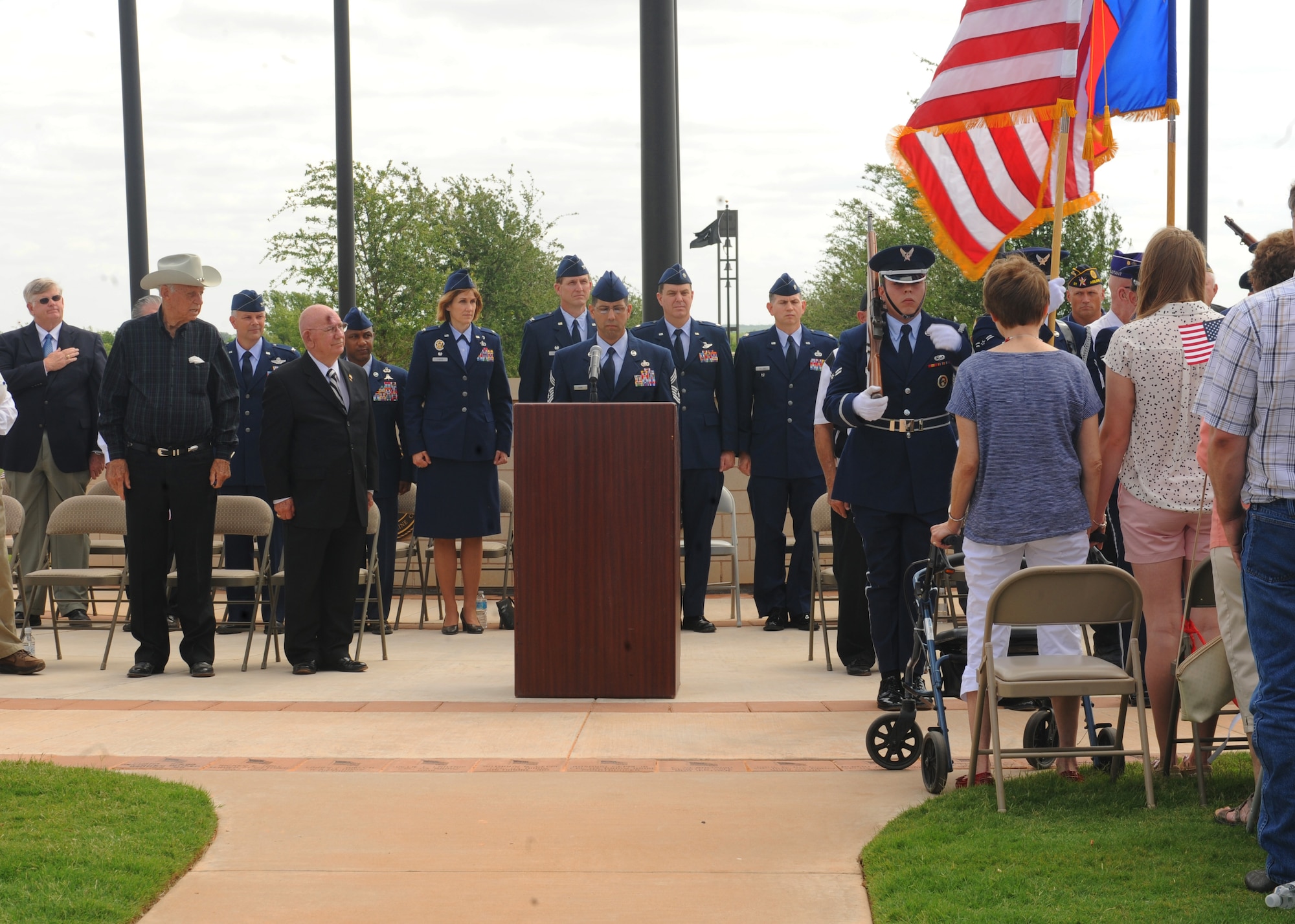 Dyess leadership and special honored guests listen as biographies written on Korean War veterans are read during a Memorial Day ceremony held at the Texas State Veterans Cemetery in Abilene, Texas, May 27, 2013. The Korean War, which was fought from 1950-1953, left a total of 36, 516 U.S. servicemembers dead and 92,134 wounded. (U.S. Air Force photo by Senior Airman Cierra Presentado/Released)