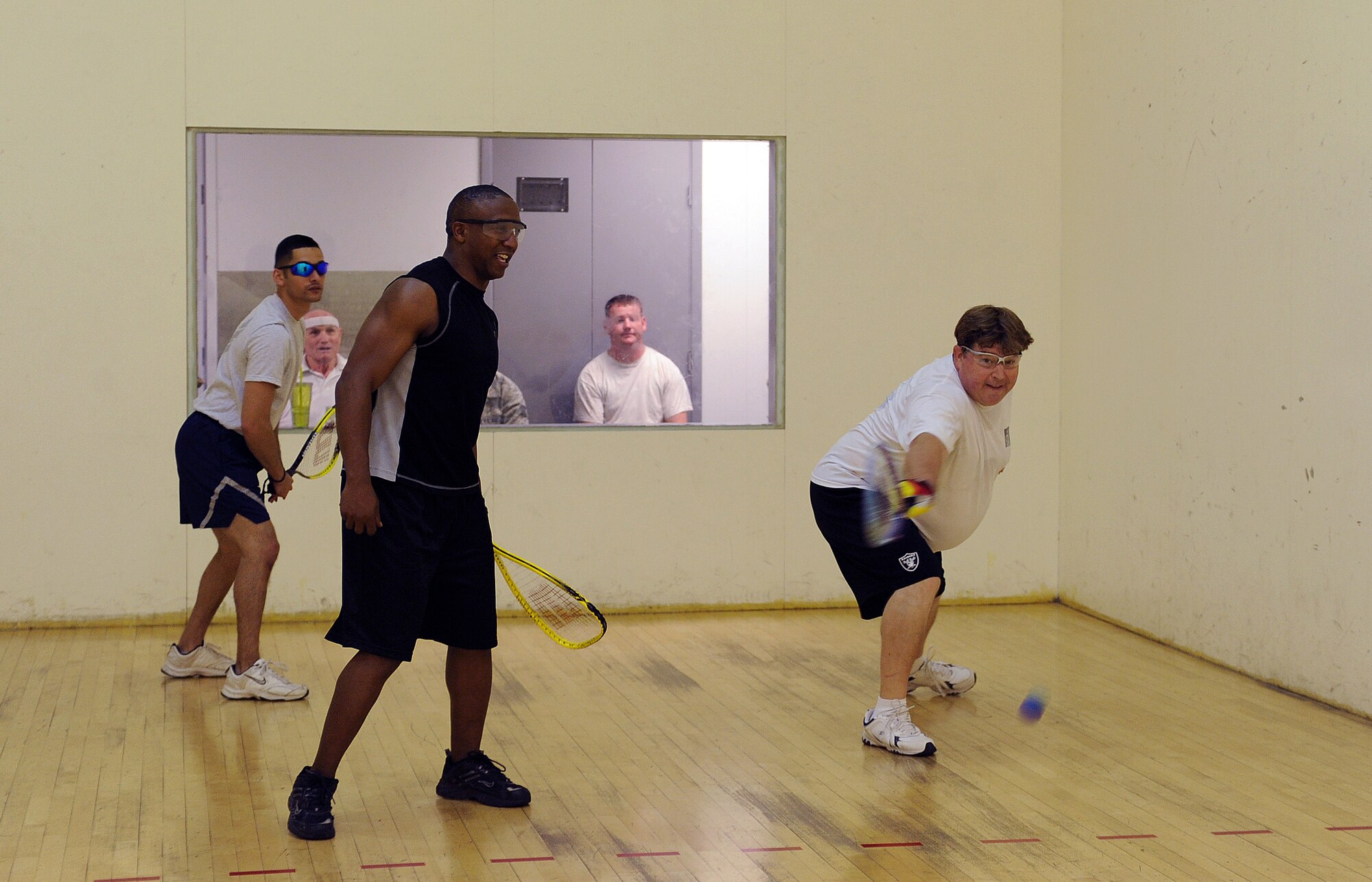 U.S. Air Force Civilian Gregory Padilla, 355th Security Forces Squadron attacks the ball during the racquetball tournament held May 22, 2013 for Comprehensive Airman Fitness Week at Davis-Monthan Air Force Base, Ariz. Both Senior Master Sgt. Terry Hennings and Staff Sgt. Covito Redman, 355th Medical Group were rewarded a day off from work for winning the tournament. (U.S. Air Force photo by Airman 1st Class Christine Griffiths/Released)