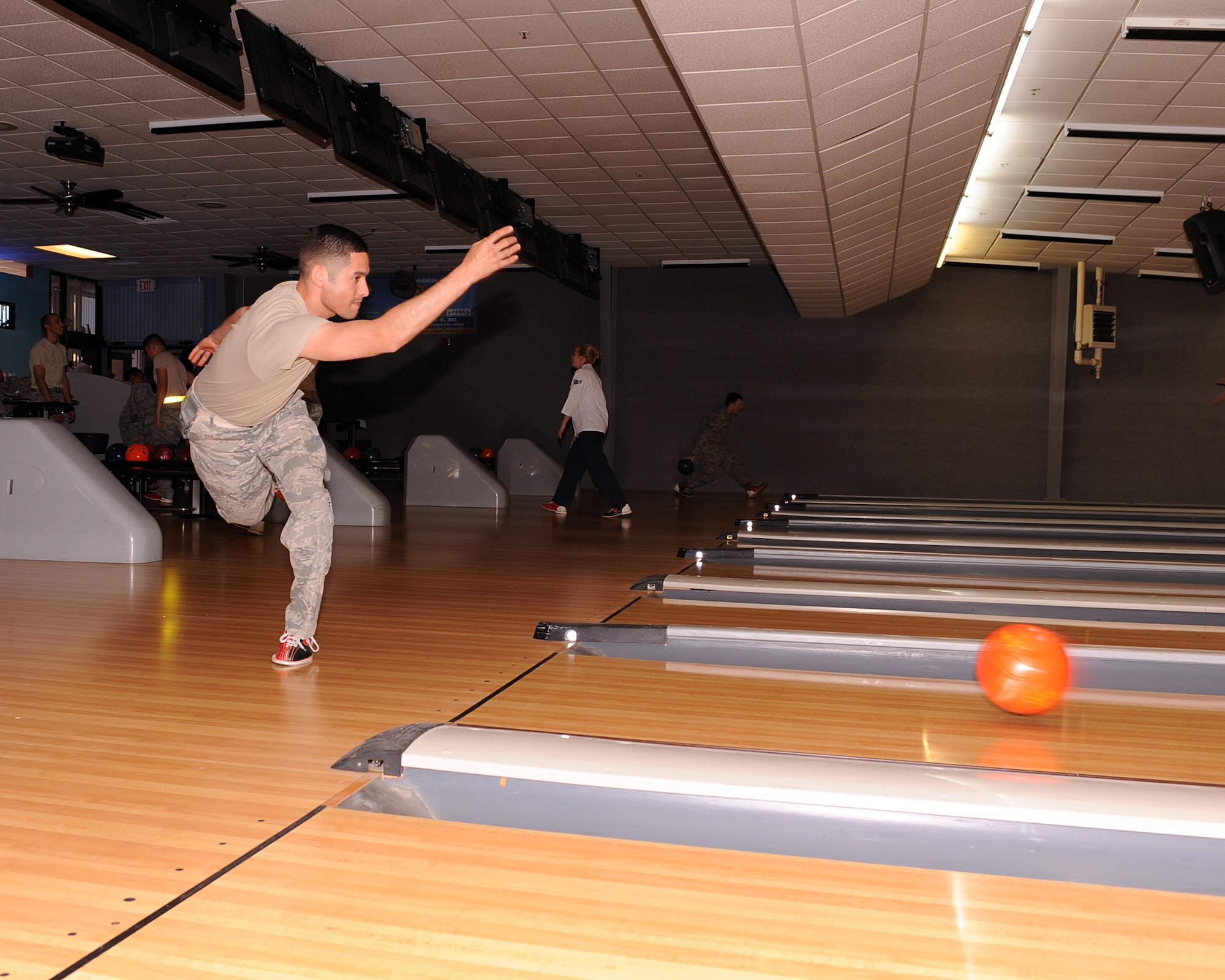 U.S. Air Force 2nd Lt. Joseph Cortez, 355th Security Forces Squadron rolls a bowling ball down the lane during the Comprehensive Airman Fitness Week's Bowling Tournament at Davis-Monthan Air Force Base, Ariz., May 21, 2013.  Tech. Sgt Christine Wright and Airman 1st Class Kevin Brodeur, 355th Operation Support Squadron were the wingman team that placed first in the Bowling Tournament. (U.S. Air Force photo by Airman 1st Class Christine Griffiths/Released) 