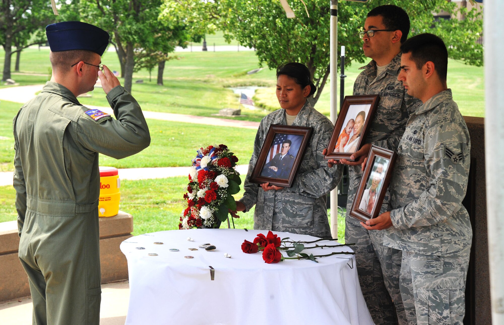 An Airman pays his respects toward a memorial display honoring Capt. Mark Tyler Voss, Capt. Victoria A. Pinckery and Tech. Sgt. Herman “Tre” Mackey, III during a Shell 77 Memorial Service at McConnell Air Force Base, Kan., May 28, 2013. The service allowed people to pay their respects and remember the aircrew, who were assigned to the 93rd Air Refueling Squadron, Fairchild AFB, Wash., and died tragically May 3, when their KC-135 Stratotanker crashed in Kyrgyzstan in Support of Operation Enduring Freedom. (U.S. Air Force photo/ Staff Sgt. Jess Lockoski)