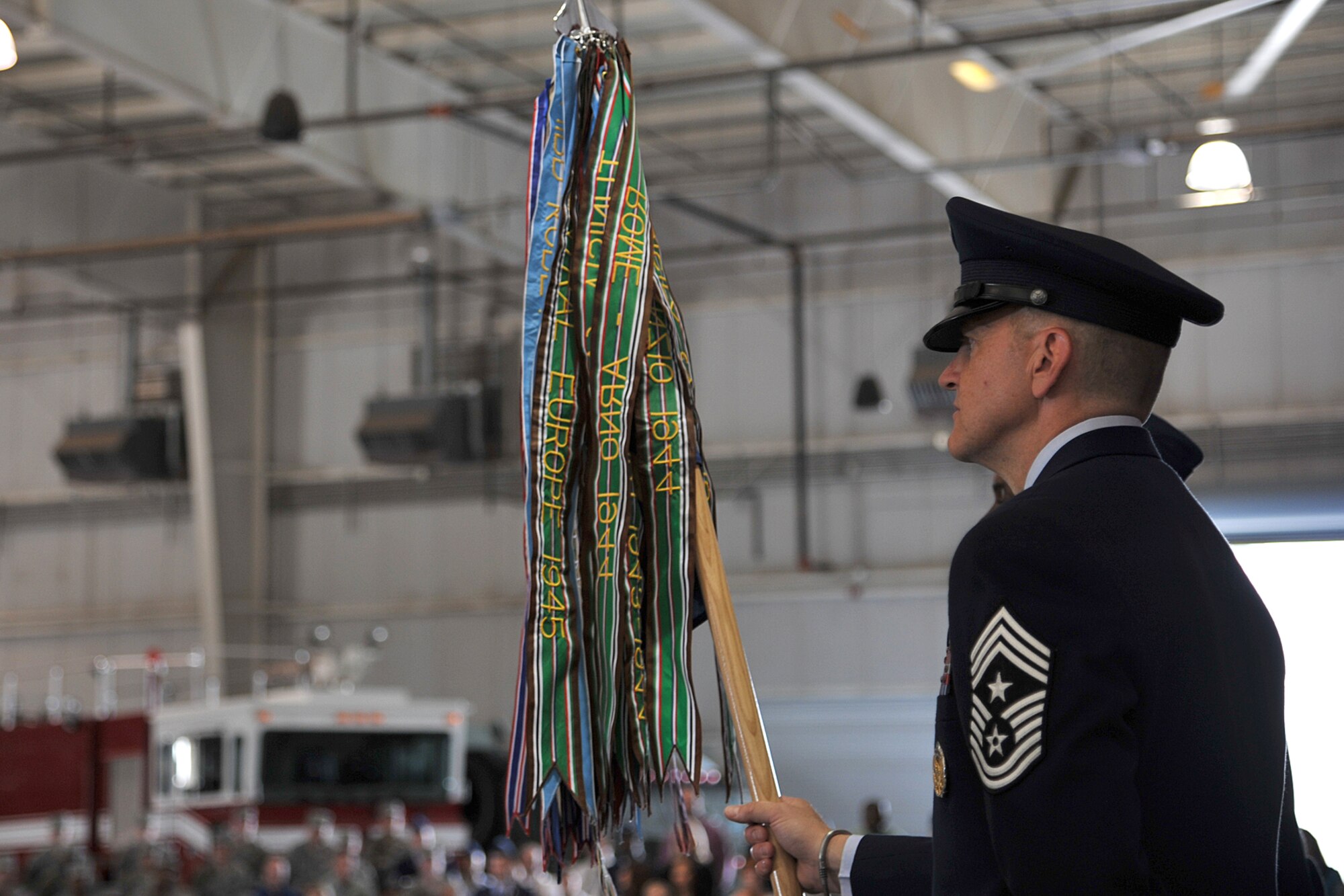 GOODFELLOW AIR FORCE BASE, Texas - Chief Master Sgt. Scott Lumpkin, 17th Training Wing Command Chief, holds the 17th TRW guidon during the Change of Command ceremony at the Louis F. Garland Fire Academy high bay, May 29. The ceremony commemorated Col. Mark Damiano relinquishing command of the 17th Training Wing to Col. Kimberlee Joos. (U.S. Air Force photo/ Senior Airman Michael Smith)