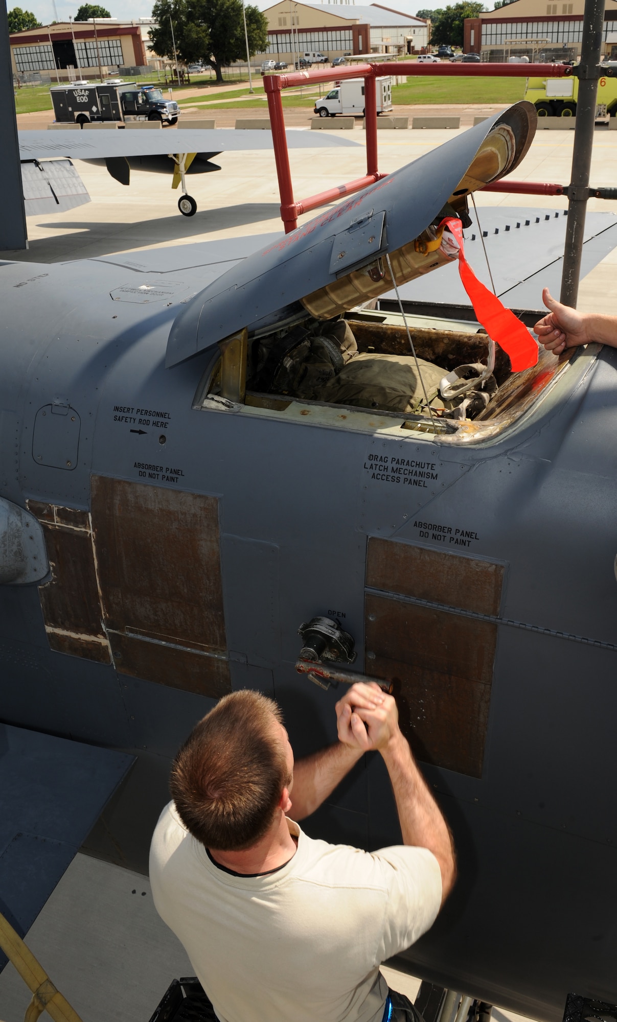 Staff Sgt. Richard Sturm, 20th Aircraft Maintenance Unit crew chief, closes a B-52H Stratofortress drag chute hatch on Barksdale Air Force Base, La., May 28, 2013. The B-52 uses two parachutes when landing. The first parachute that deploys is a small pilot chute. The pilot chute is used to pull out the bigger parachute which slows down the aircraft. (U.S. Air Force photo/Airman 1st Class Benjamin Gonsier)(RELEASED)