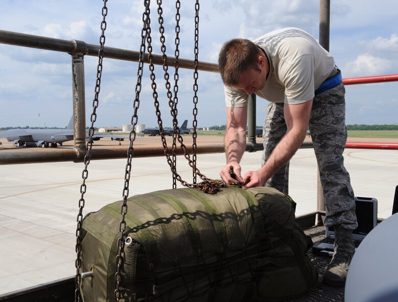Staff Sgt. Richard Sturm, 20th Aircraft Maintenance Unit crew chief, unhooks a chute bag on Barksdale Air Force Base, La., May 28, 2013. The chute bag weighs 185 pounds and requires a pulley in order to pull it up to the top of the stand. (U.S. Air Force photo/Airman 1st Class Benjamin Gonsier)